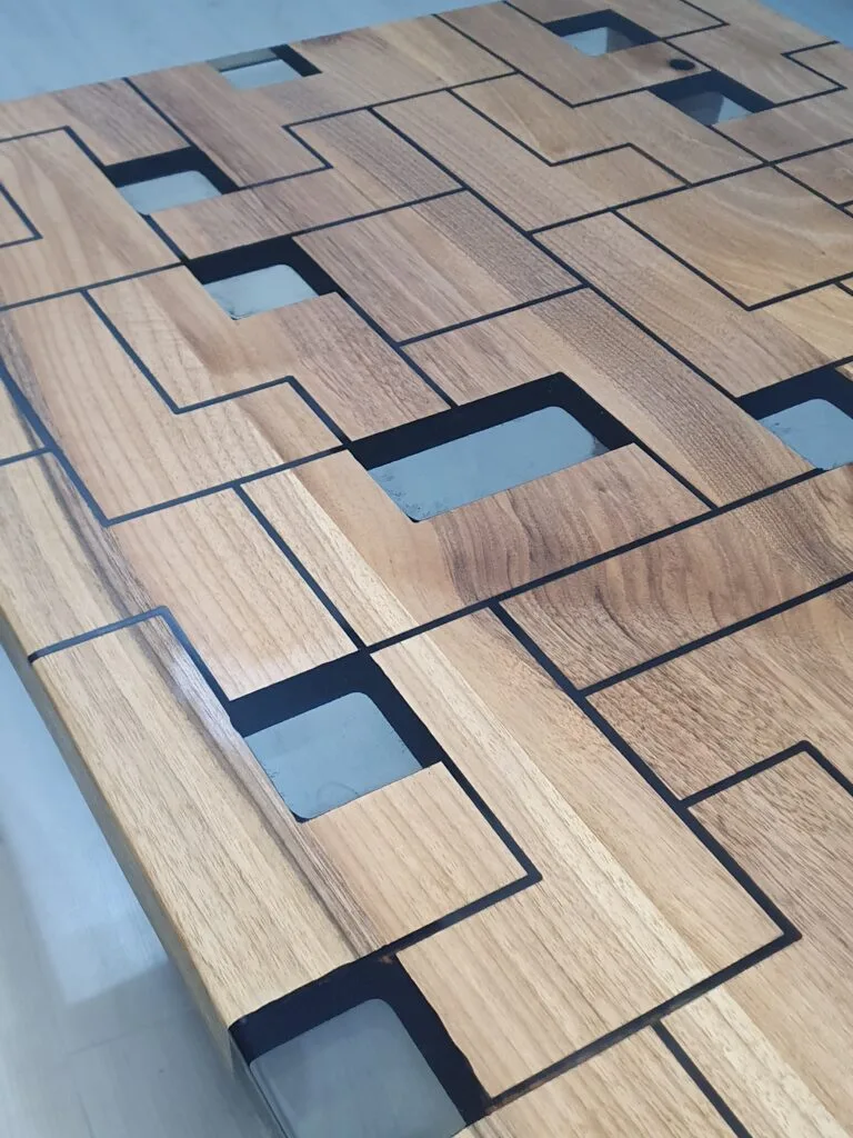 Custom rectangular coffee table made from solid walnut wood and clear epoxy resin.