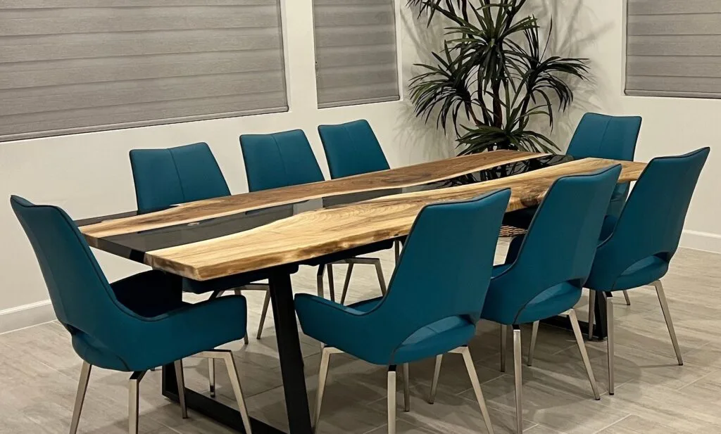 A modern and stylish dining table with a glossy epoxy river design flowing through natural wood.