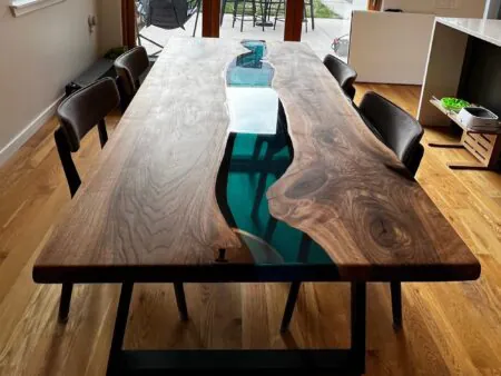 Custom transparent blue epoxy dining table in modern interior