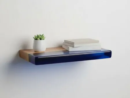 Floating live edge walnut shelf with transparent epoxy