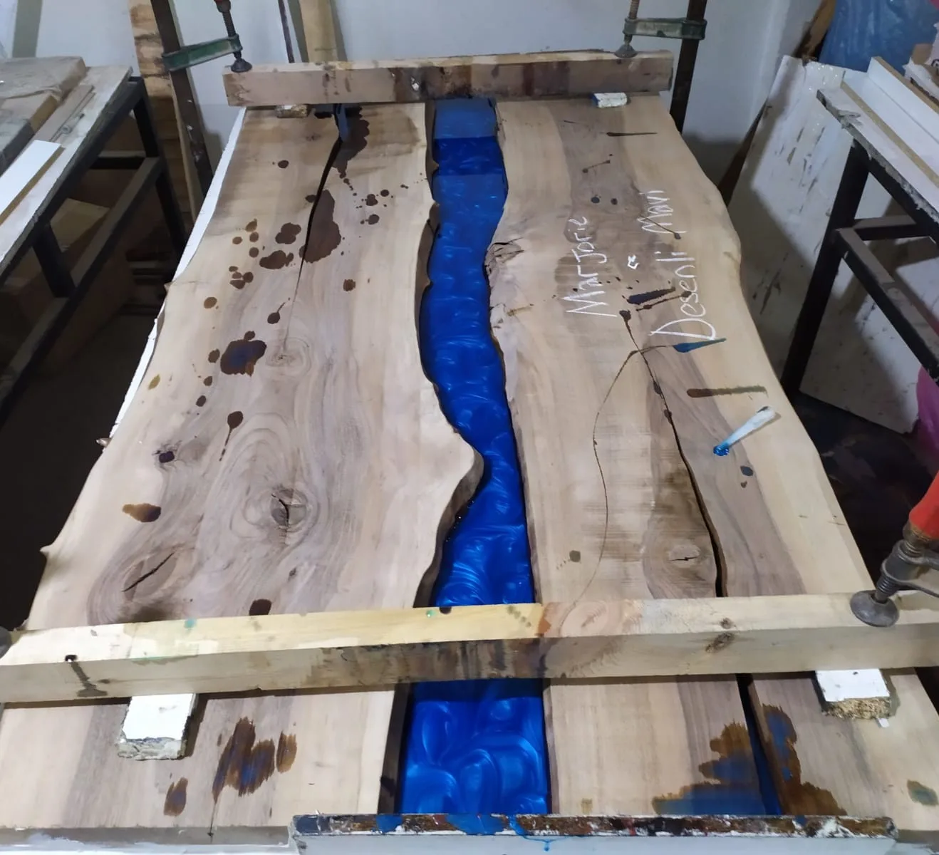 artisan making epoxy river table by hand