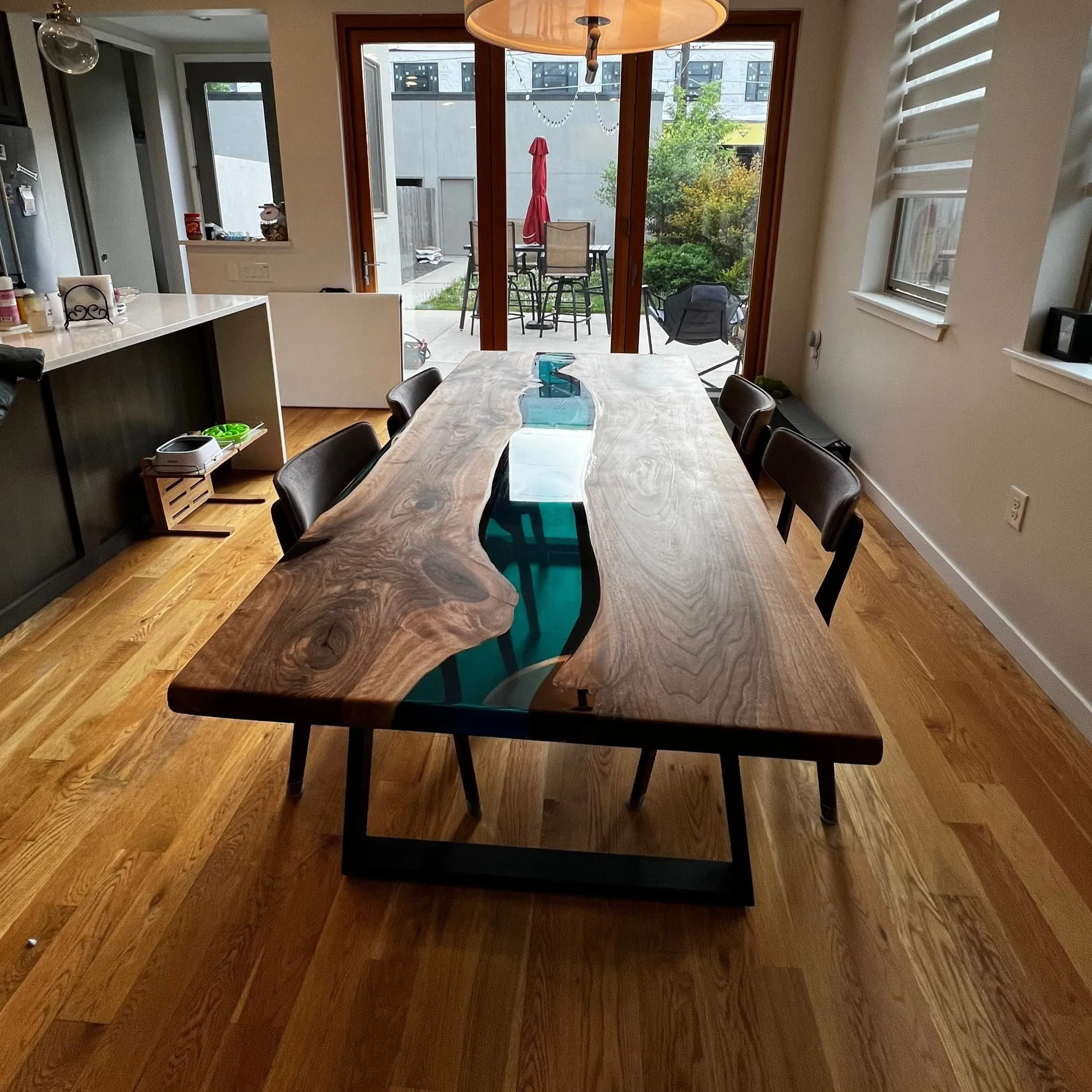 Styled dining room with blue epoxy walnut table