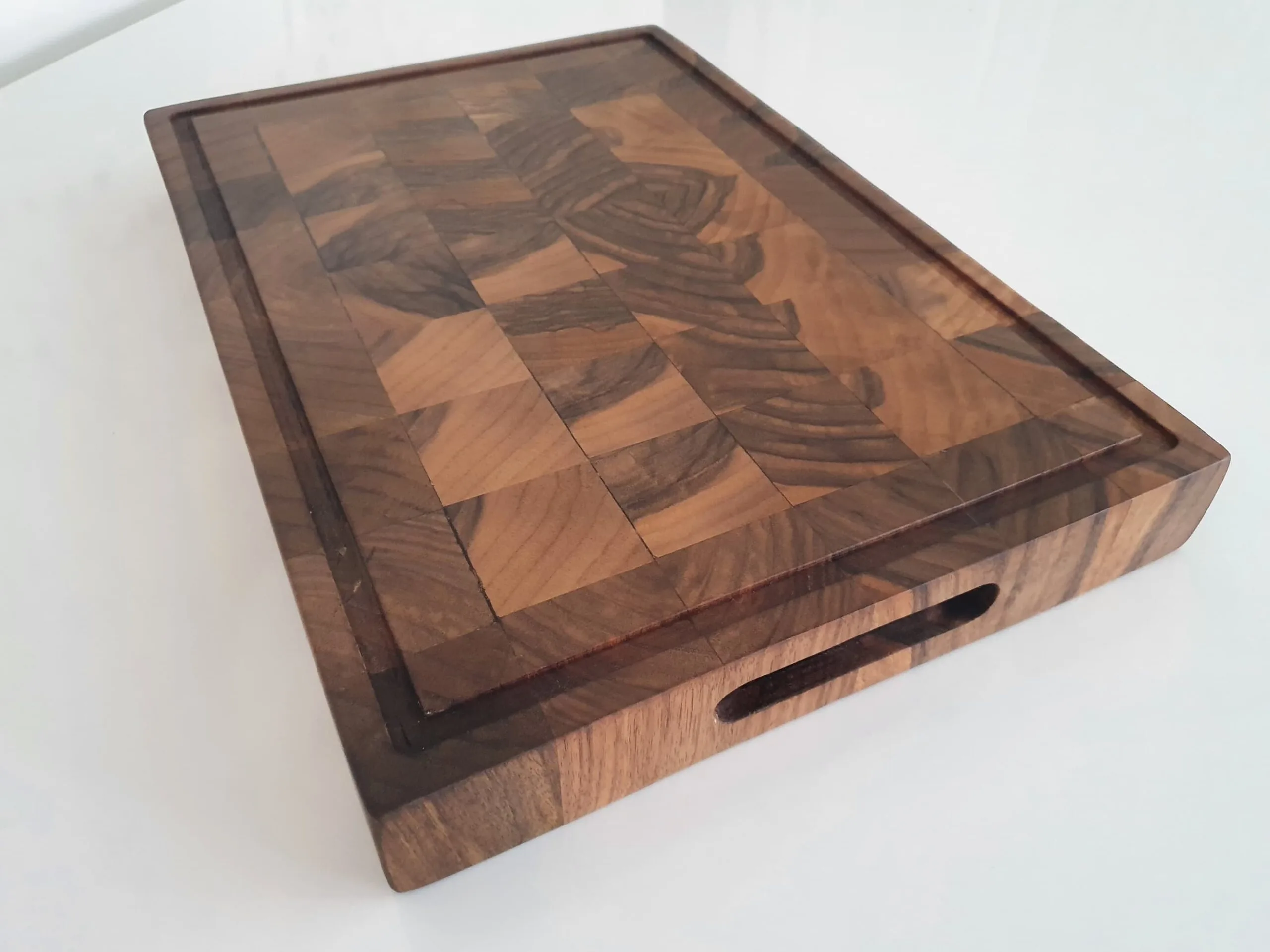 Grip insets on walnut end grain chopping board