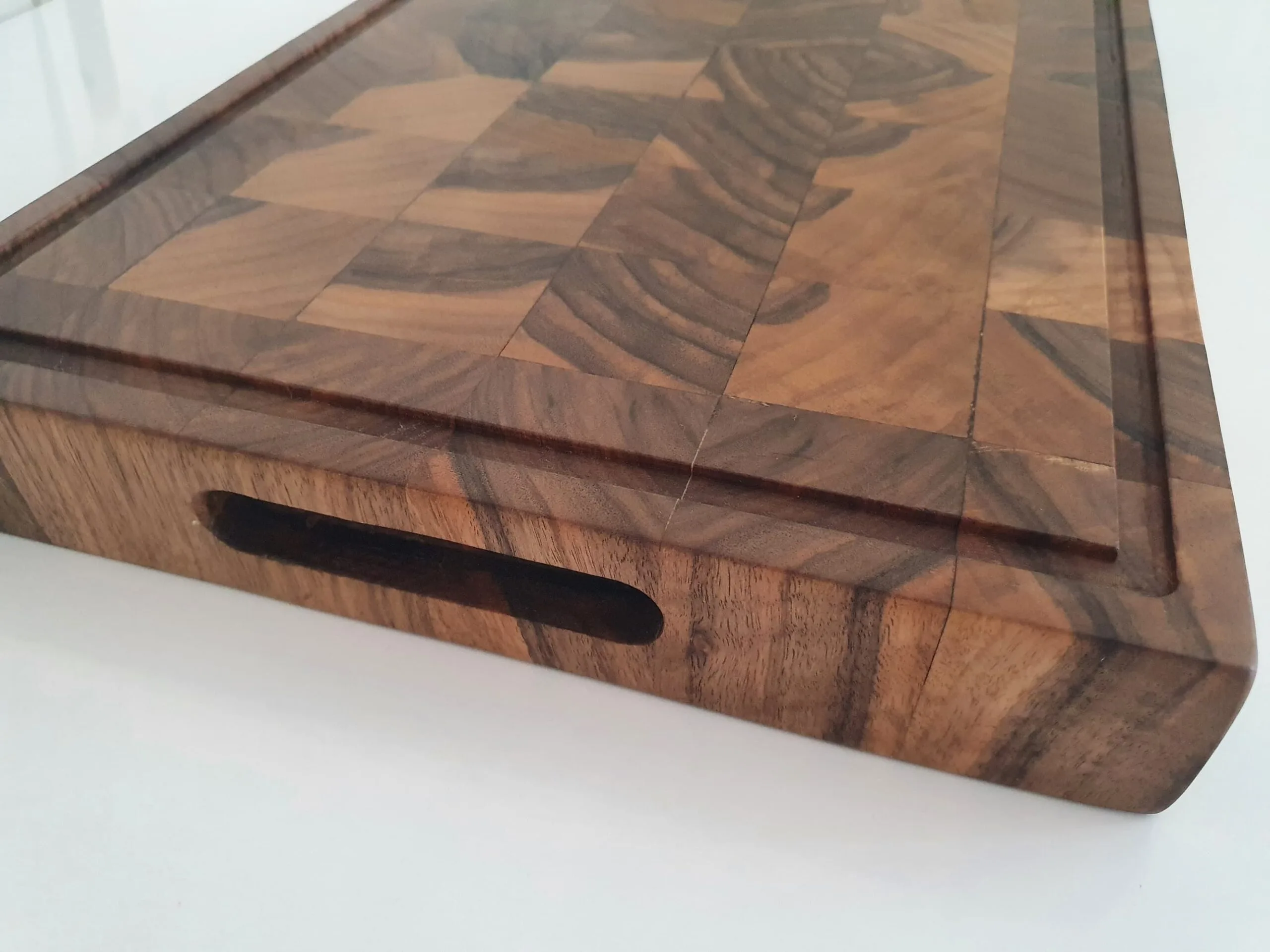 Closeup of juice groove on walnut end grain cutting board