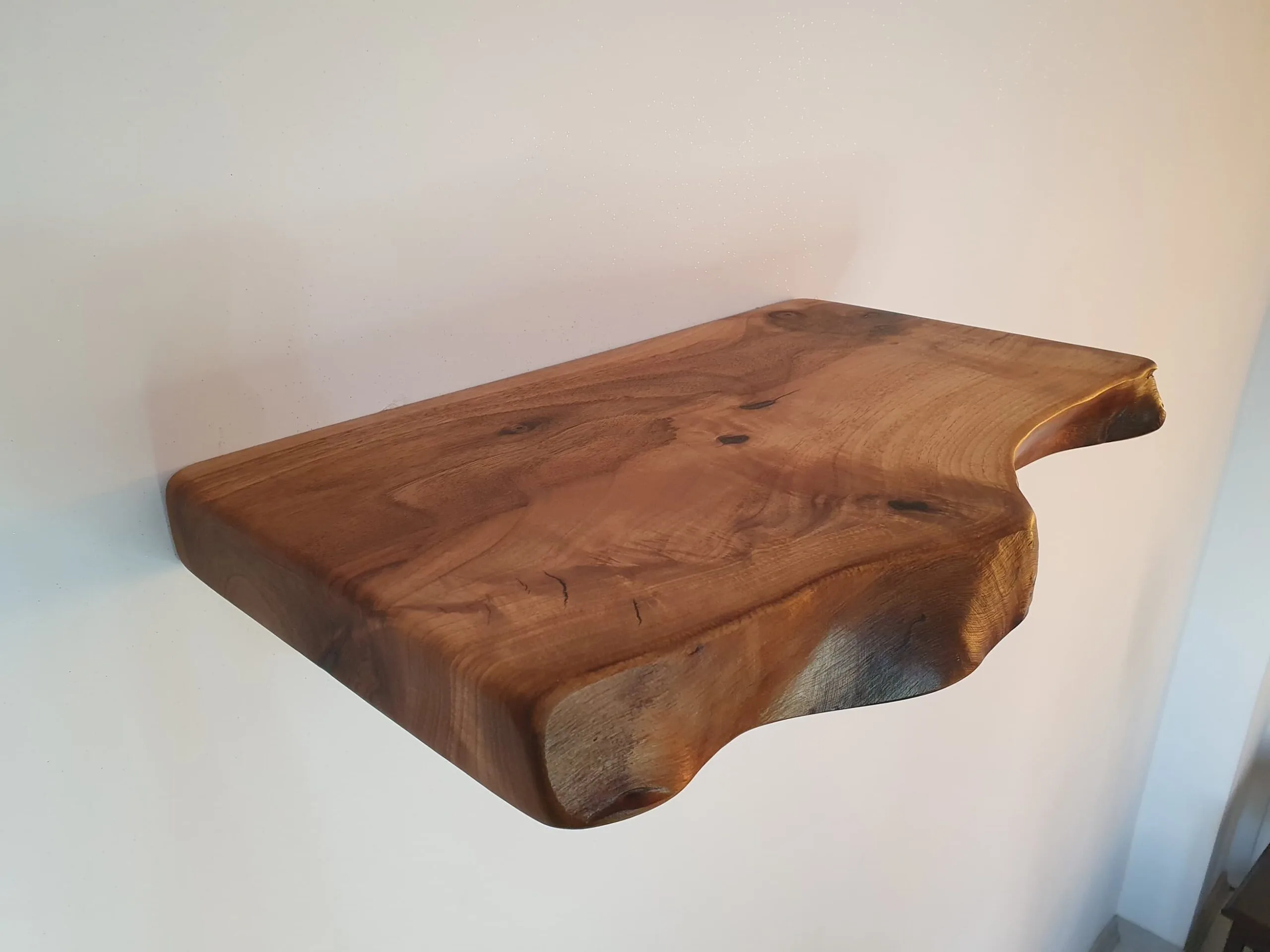 Handcrafted walnut shelf with live edge finish