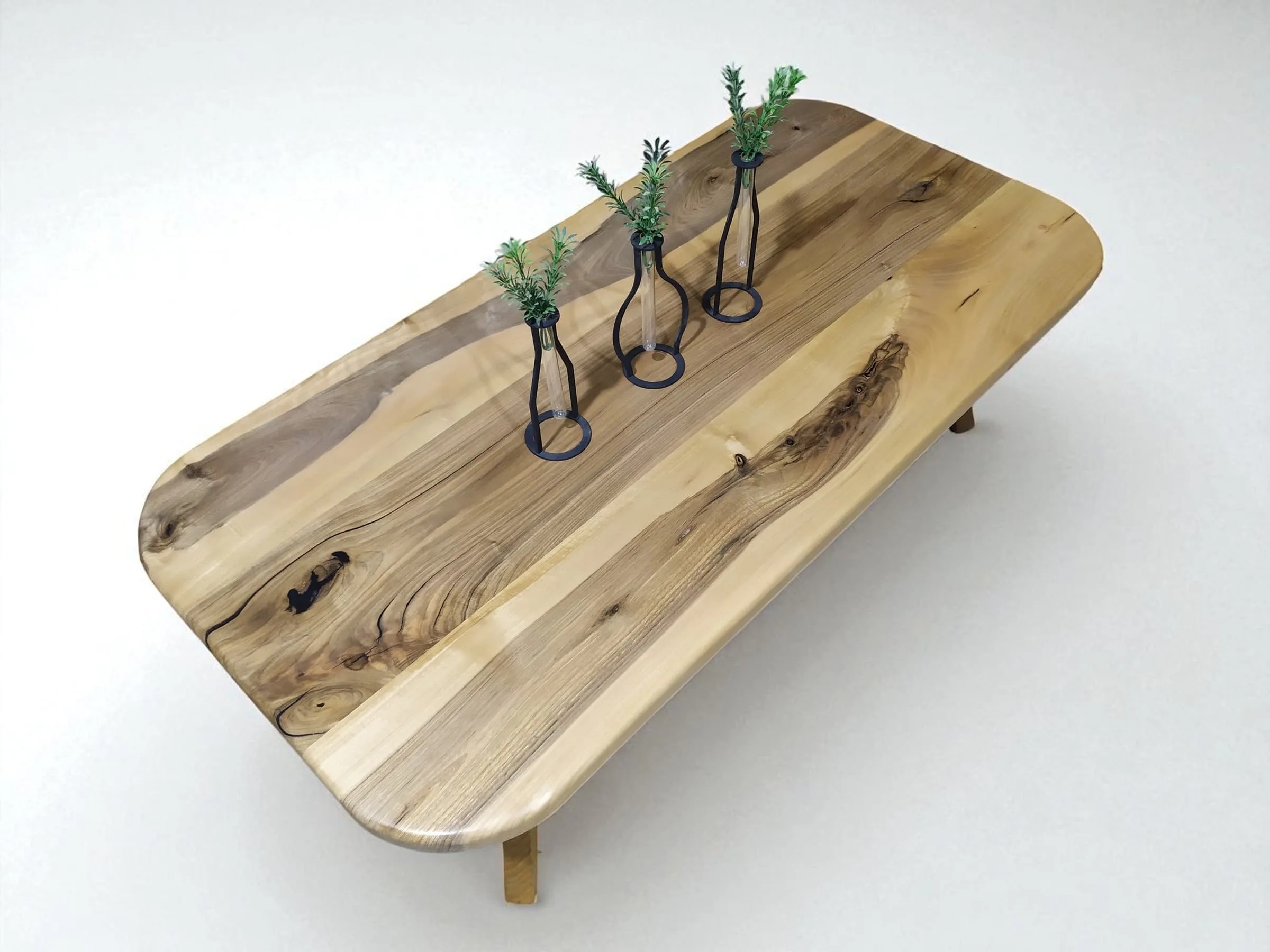 Modern walnut coffee table with rounded corners styled in bright room