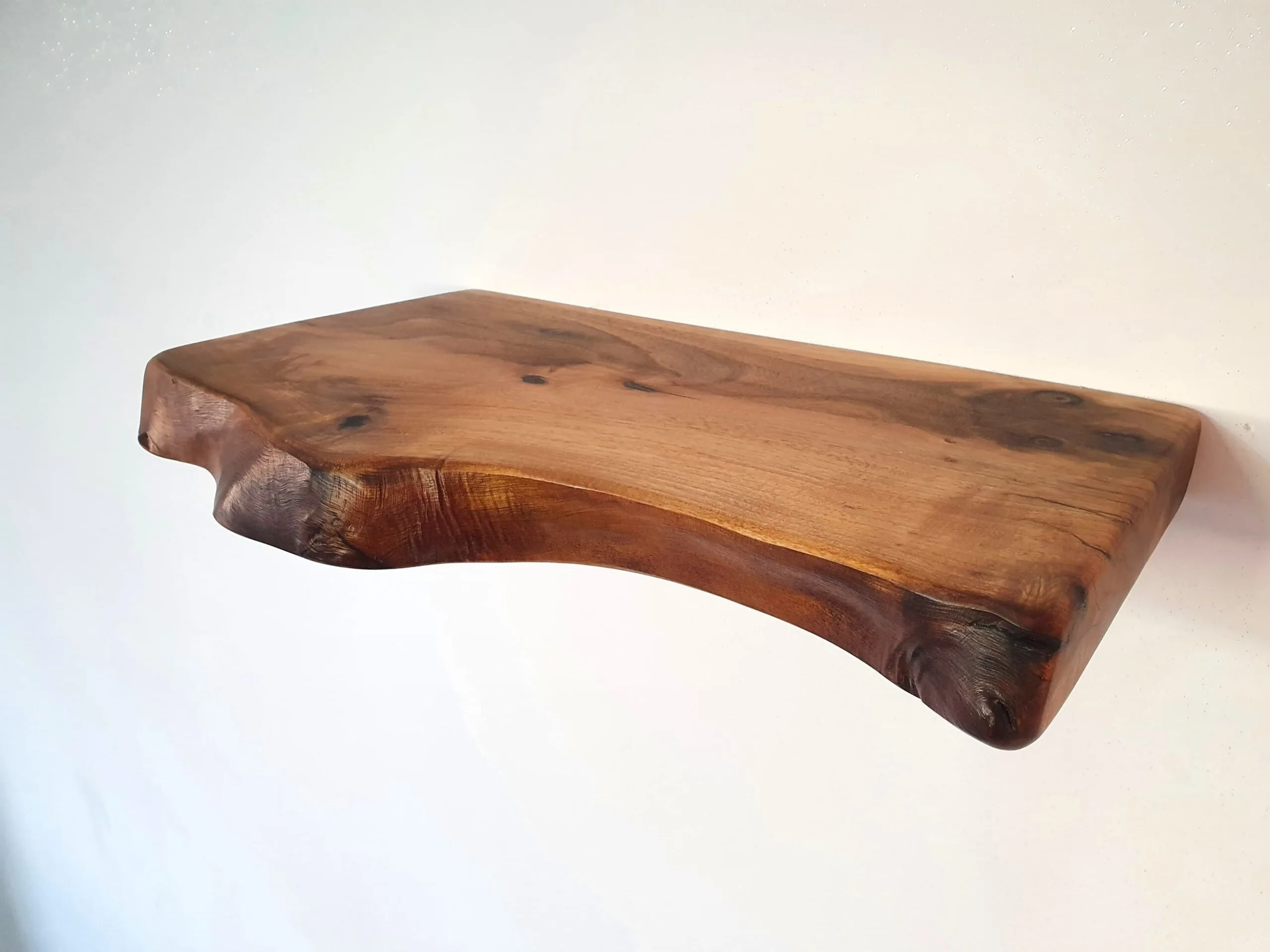 Floating live edge shelf mounted on wall