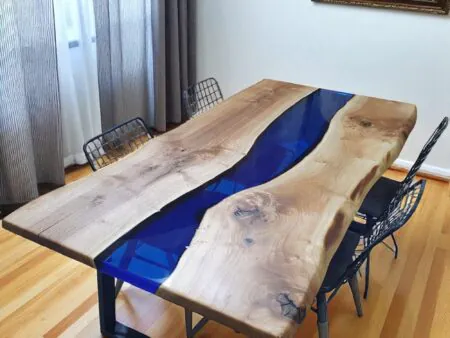 Blue epoxy river dining table with natural walnut slabs