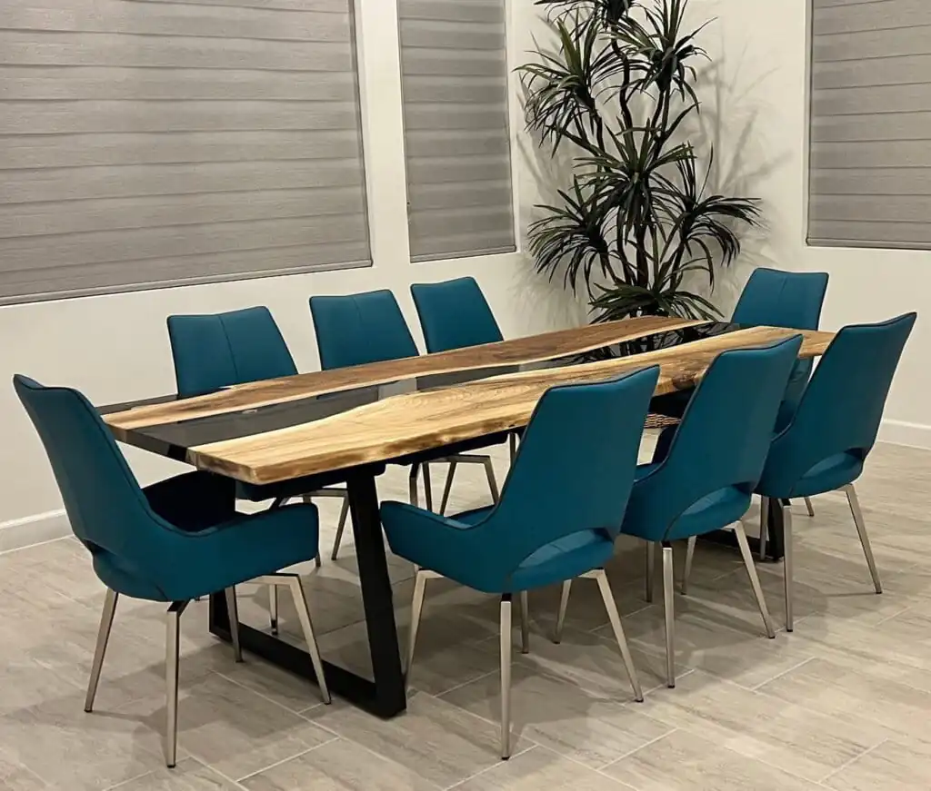 A modern and stylish dining table with a glossy epoxy river design flowing through natural wood.