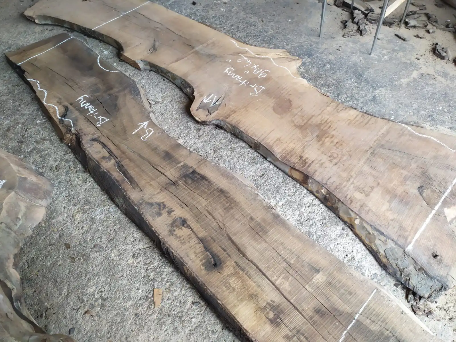 Kiln-dried European walnut wood slabs selected for crafting a custom live edge epoxy table.
