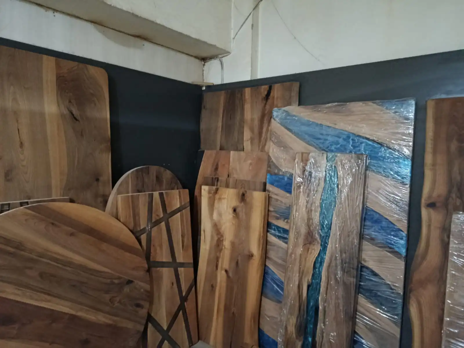 A collection of finished epoxy and live edge wood dining tables in stock and ready for global shipping.