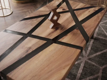 Diagonal lifestyle shot of the geometric walnut epoxy coffee table capturing the subtle sheen of the transparent black resin channels.