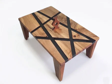 Side profile view illustrating the solid thickness and angled edge profiling of the geometric walnut epoxy coffee table on a white background.