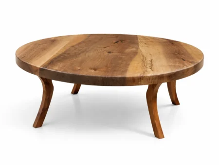 Master woodworkers hand-sanding a bespoke mid-century modern round walnut coffee table in the workshop.