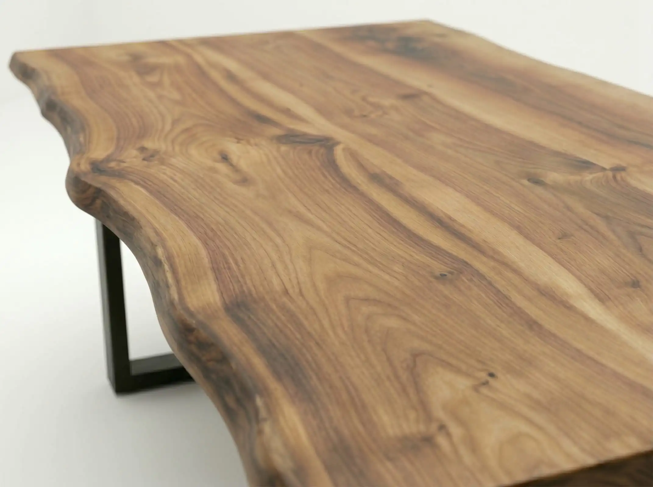 Close-up texture detail of the organic live edge boundary on a solid Live Edge Wood Coffee Table against a white backdrop.