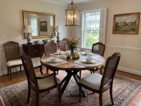 Breathtaking luxury dining room setting featuring the Round Walnut Dining Table as a contemporary centerpiece.
