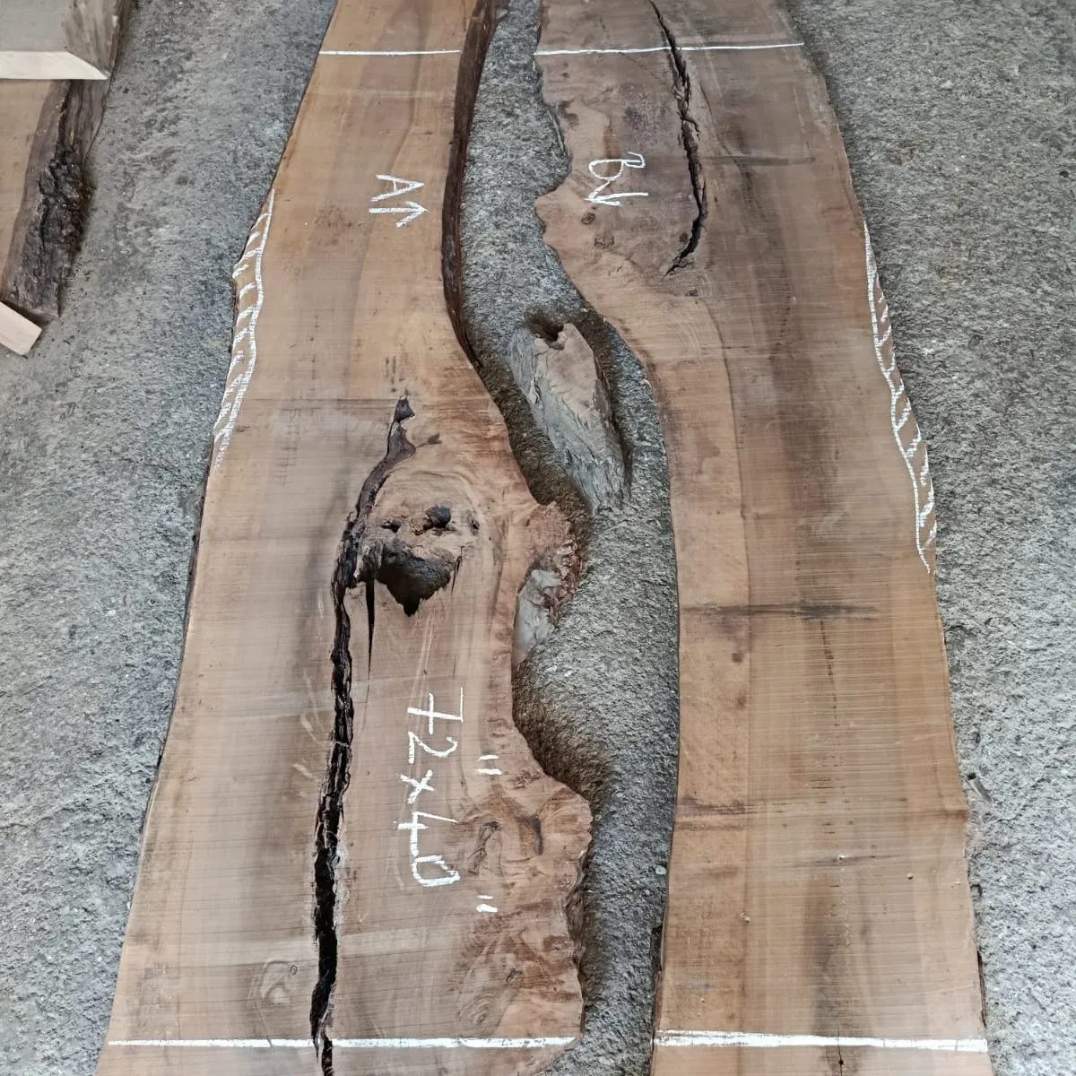 Master artisan hand-selecting and bookmatching kiln-dried European walnut slabs for an epoxy dining table with chairs.