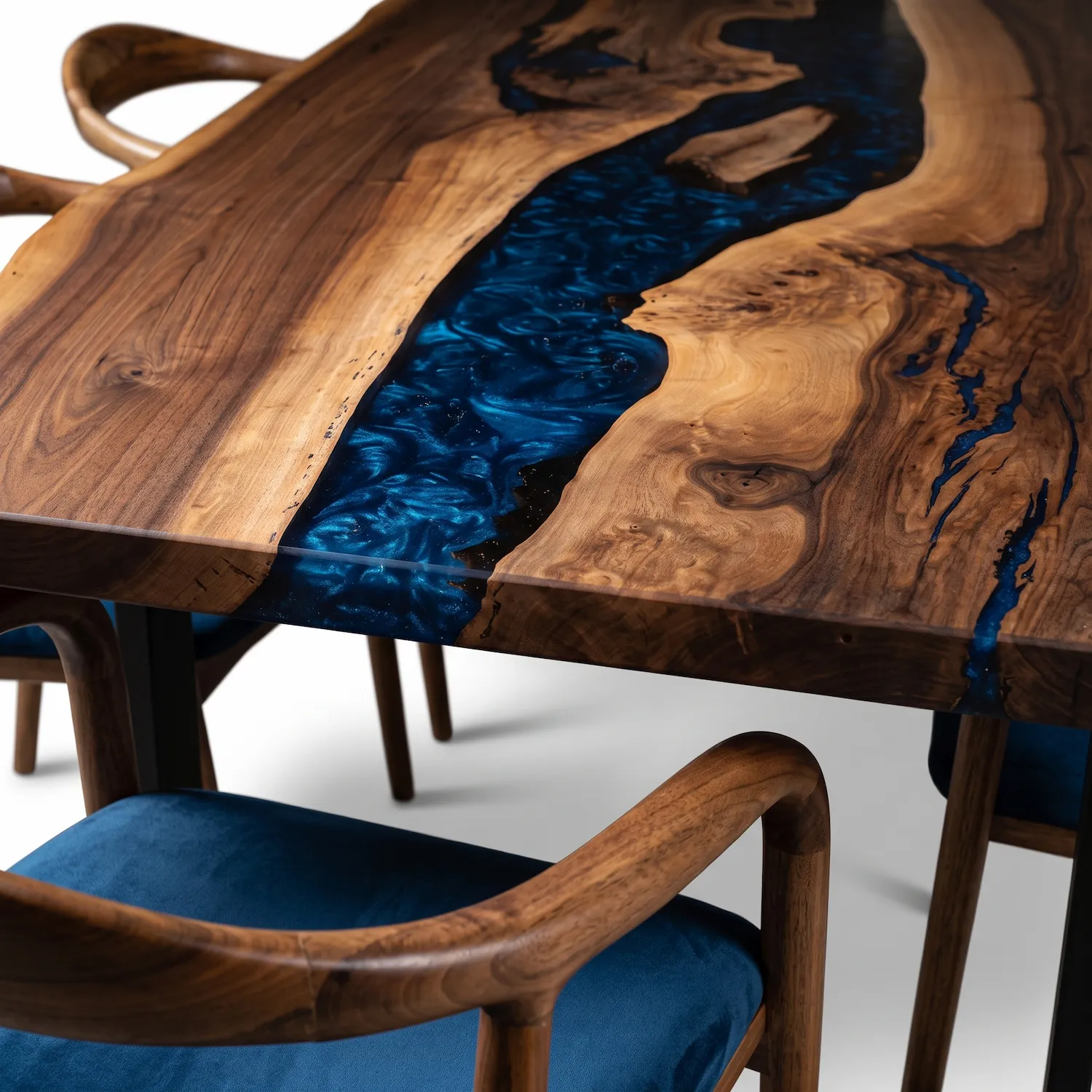 Closeup macro texture of solid walnut wood grain meeting polished navy blue epoxy river channel.