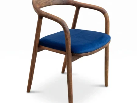 Heritage walnut dining chairs handcrafted from solid European walnut with tailored upholstery on white background.